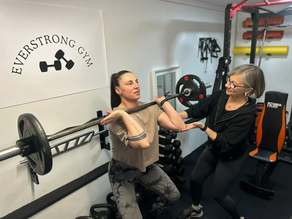 Liz Shaw coaching a barbell front rack position at The Everstrong Gym, Ealing