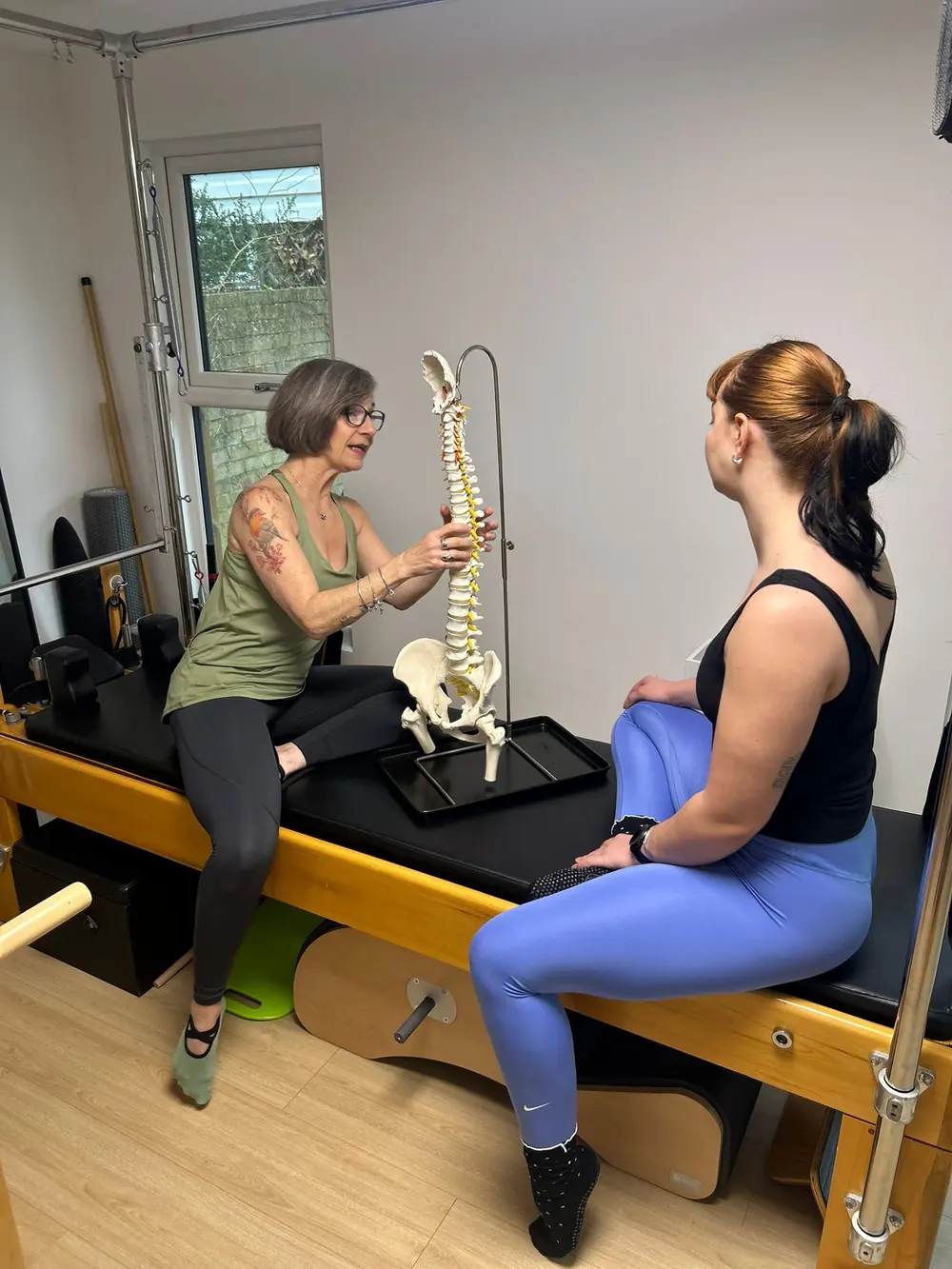 Liz Shaw explaining the spine with an anatomical model at The Willow Studio, Ealing